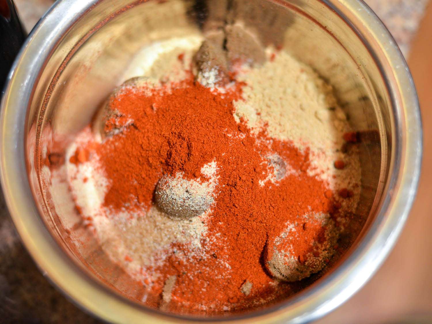 Ground spice rub ingredients inside a spice grinder