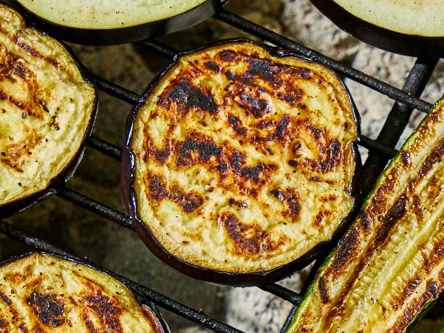 Grilled eggplant slices on a barbecue grill