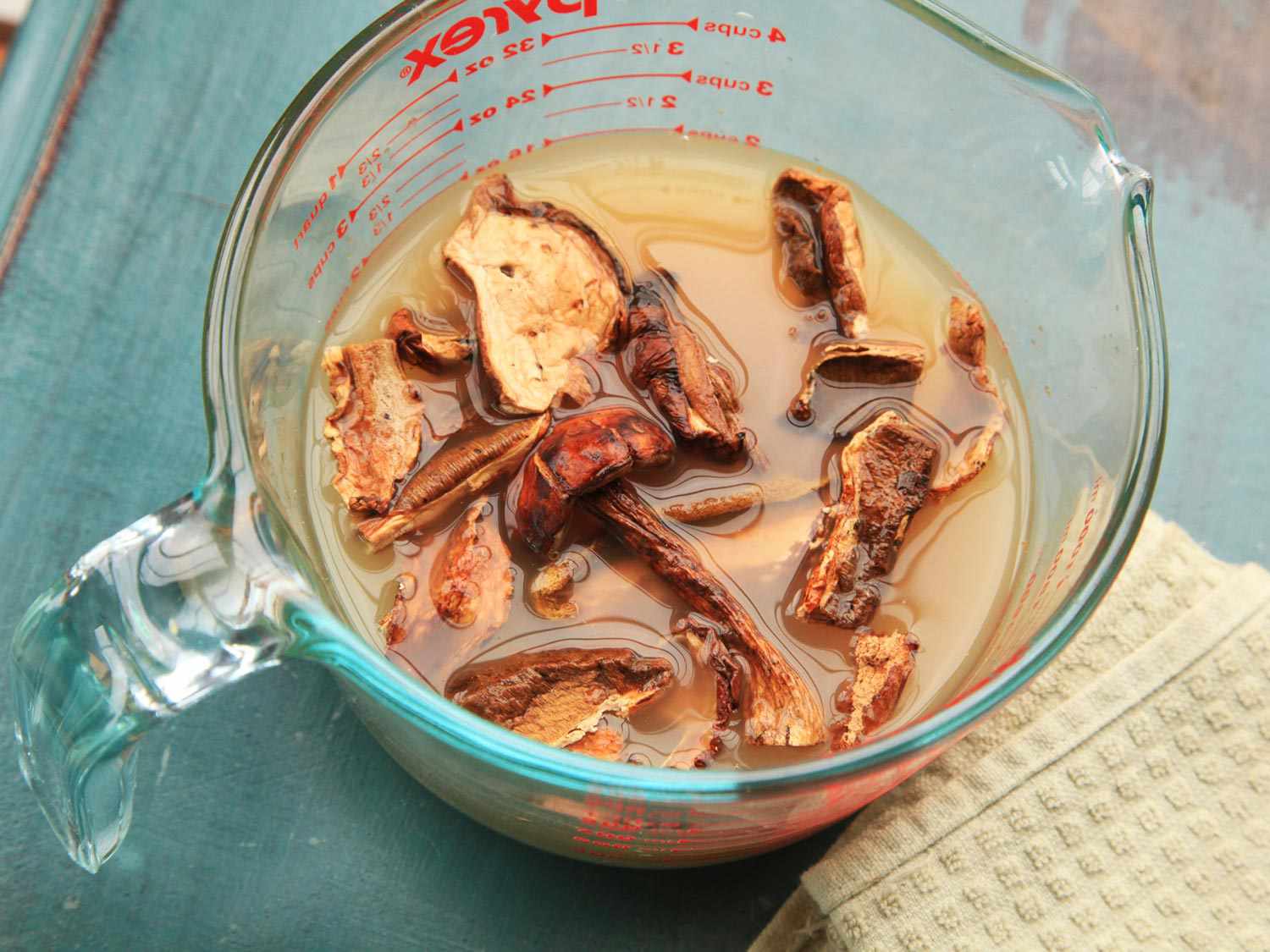 Dried porcini mushrooms soaking in broth for mushroom risotto