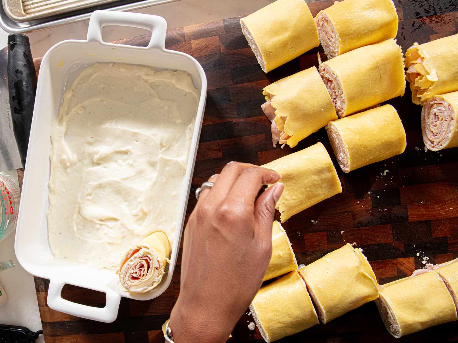 Overhead view of rolls cut and being put into the baking sheet