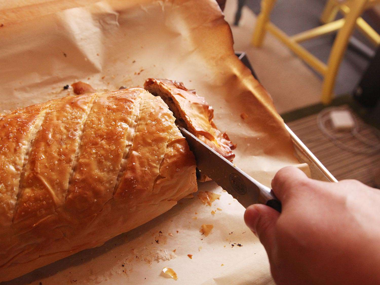Trimming ends from cooked vegetables Wellington.