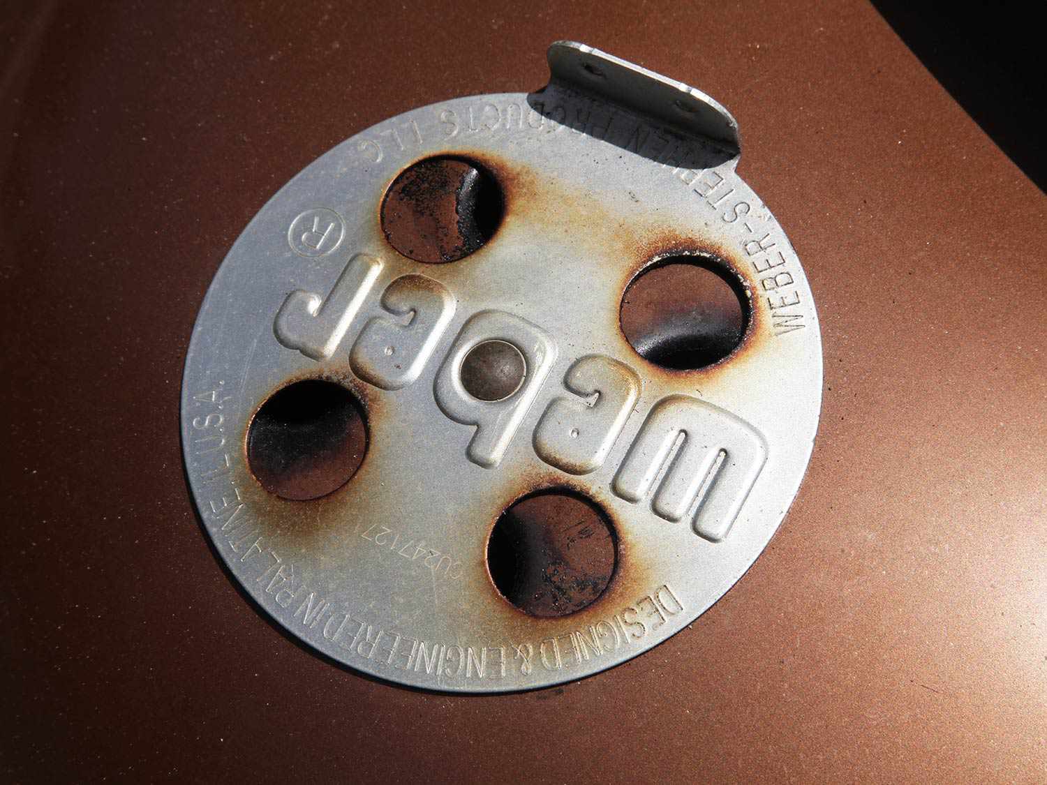 A close-up of the ventilation holes in a smoker.