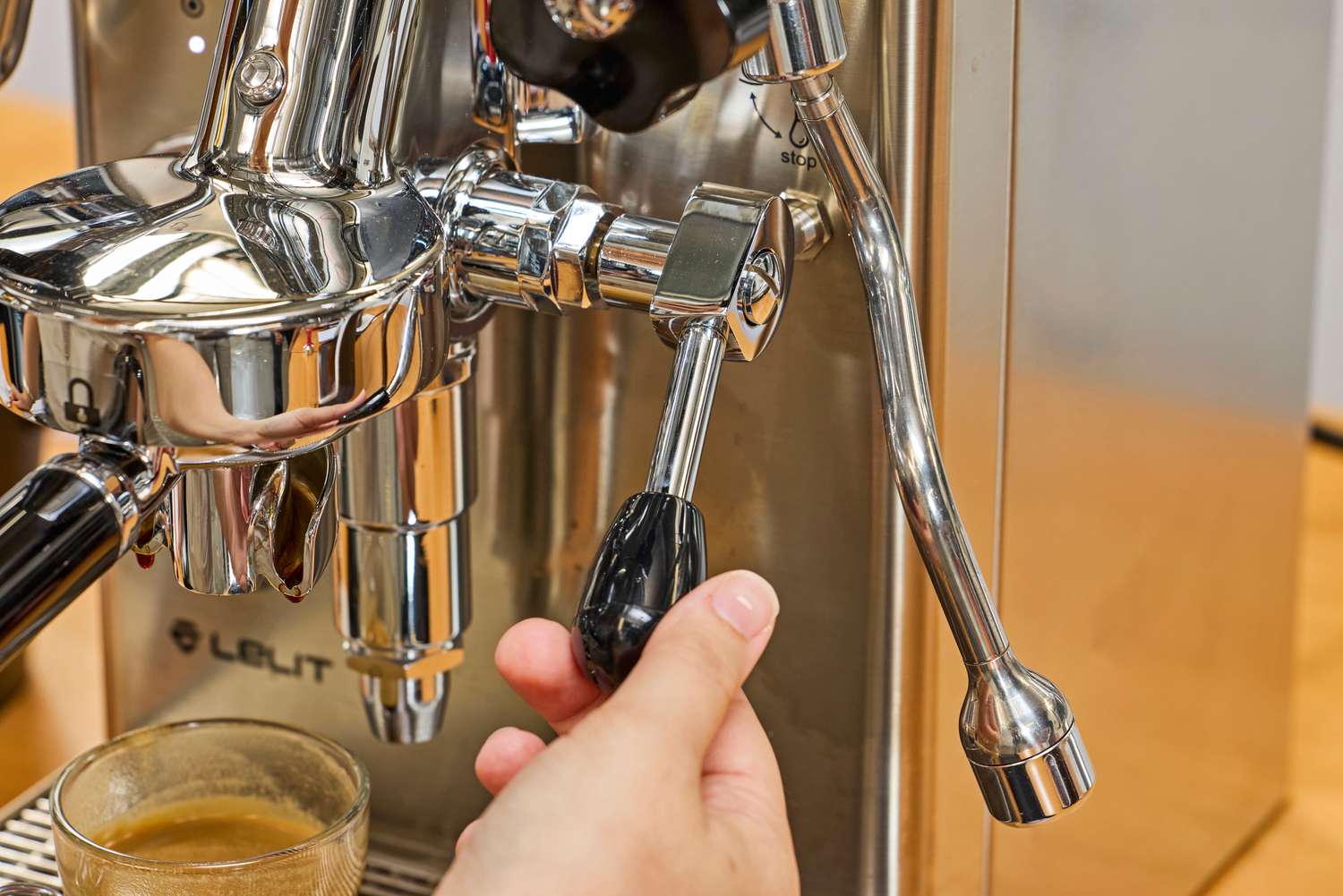 A hand holding a part of the Lelit MaraX Espresso Machine PL62X-120