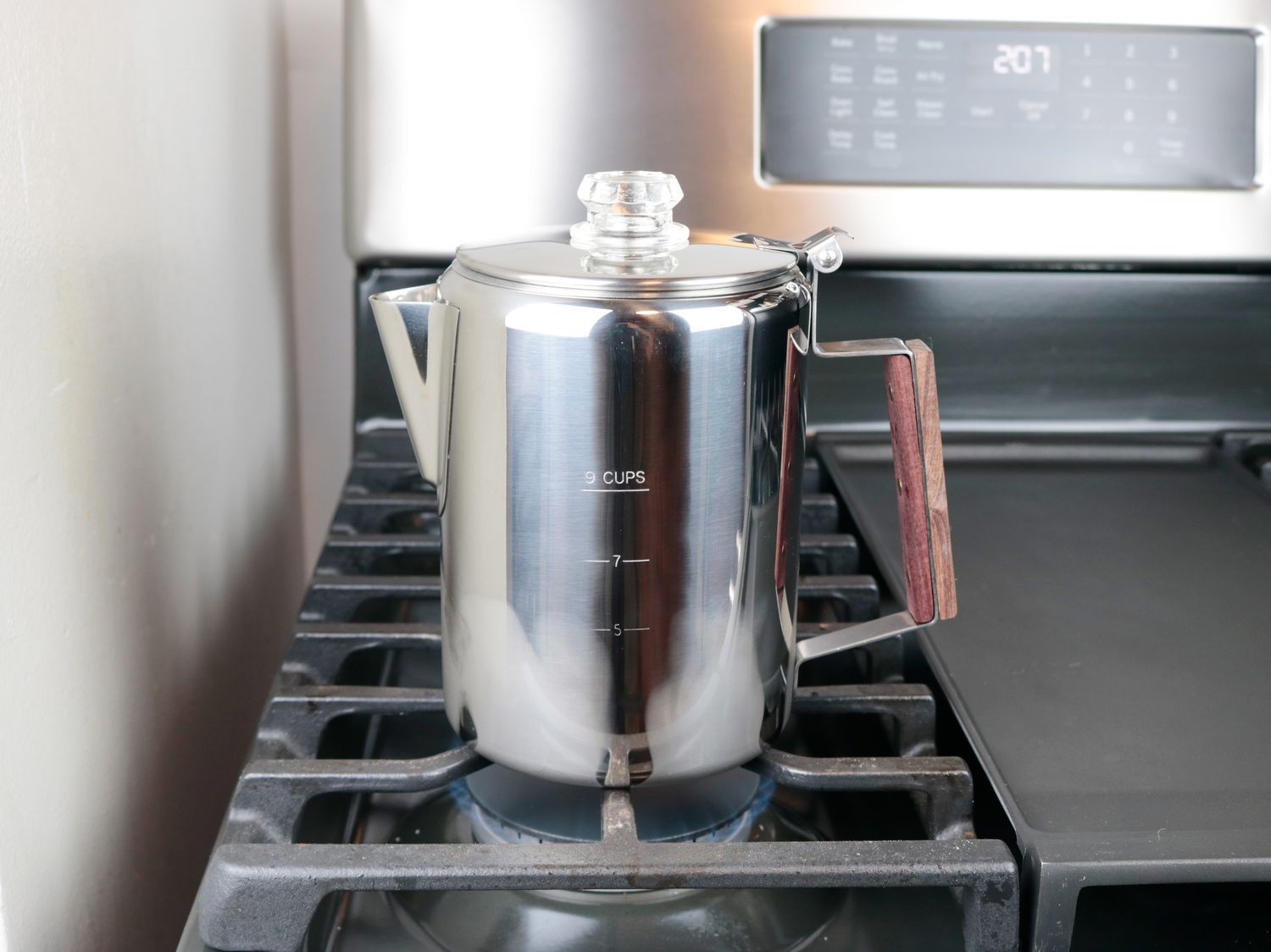 a stovetop percolator on a gas burner