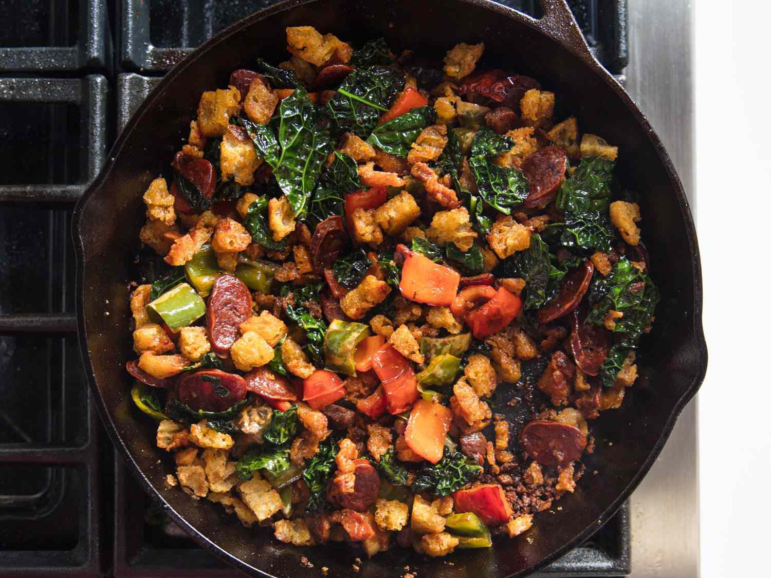 Overhead shot of finished migas in a skillet on stovetop.