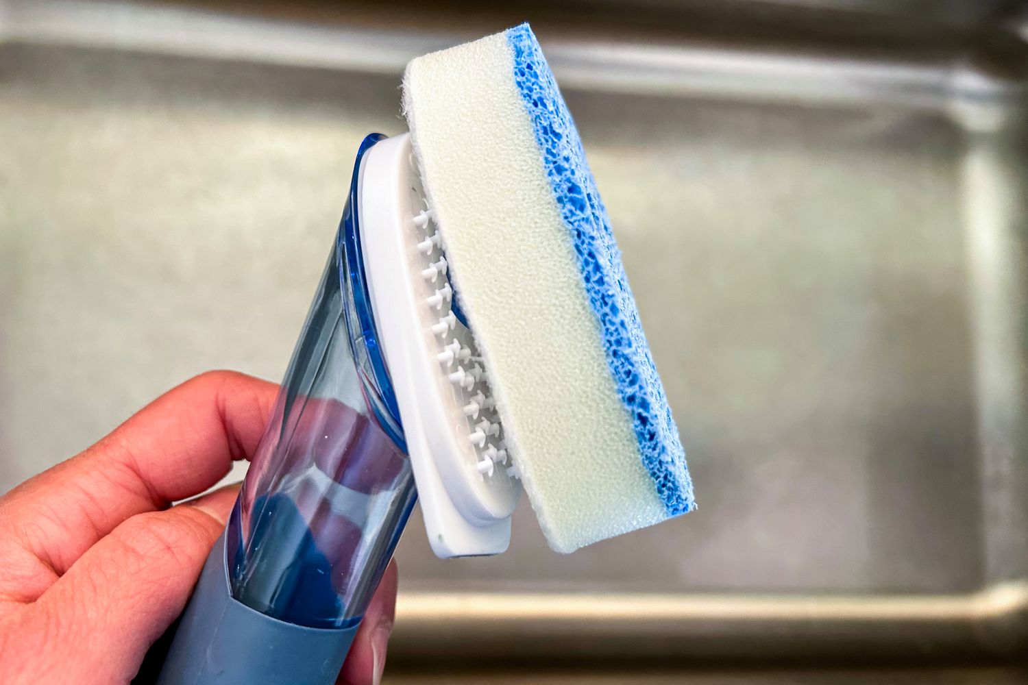 A dishwashing wand with the sponge portion falling off. 