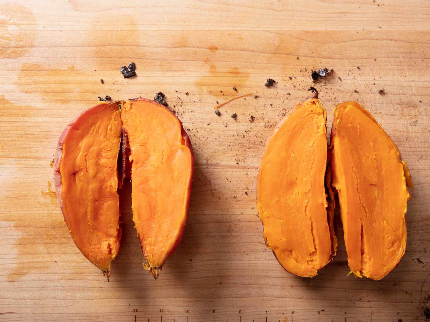 Frozen roasted sweet potatoes split with cut sides facing up to demonstrate interior texture