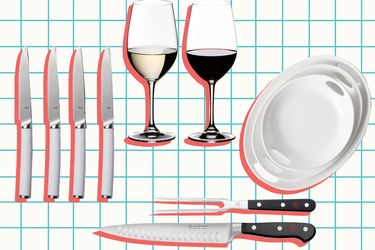 Dining set with knives wine glasses and plates arranged against a grid background