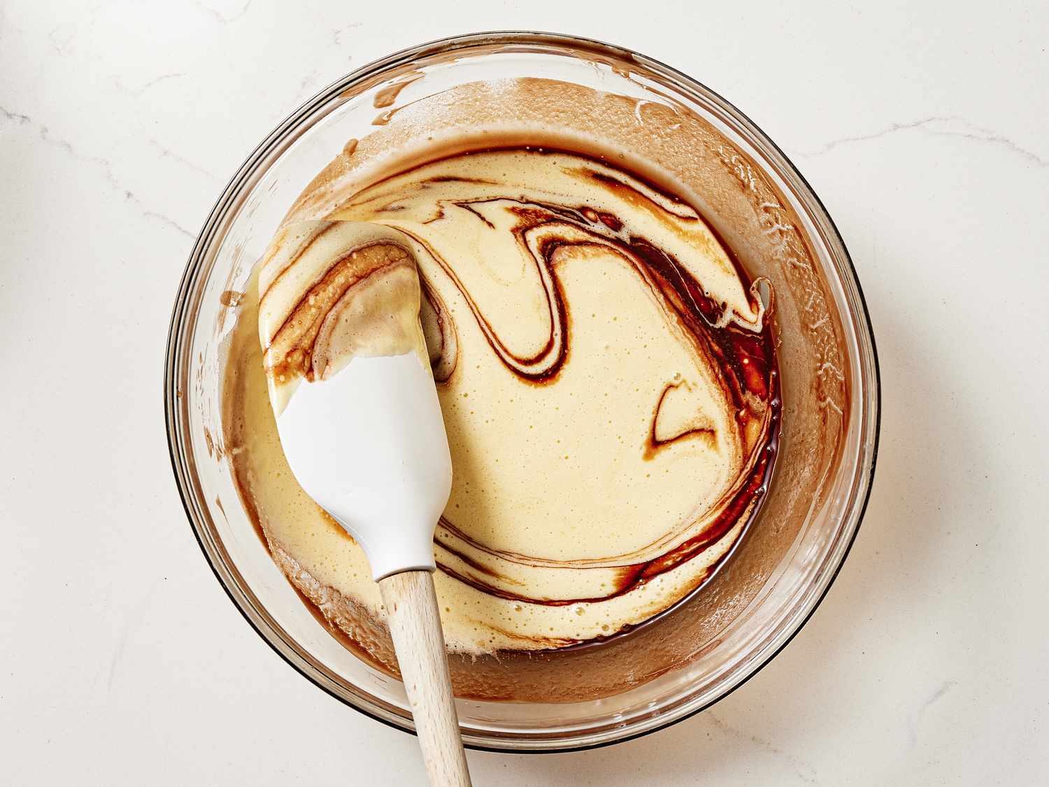 Overhead view of adding batter to chocolate 
