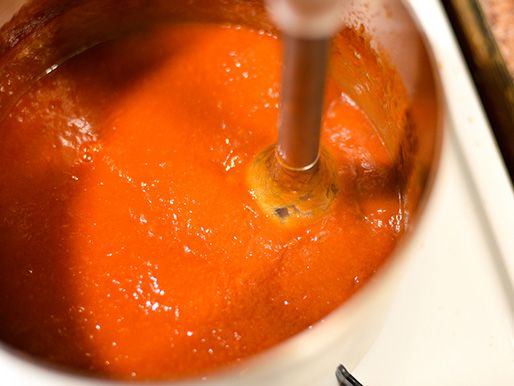 The sauce is puréed with an immersion blender in the pot.
