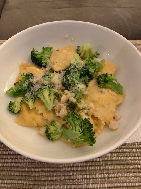 ricotta ravioli in a bowl with broccoli