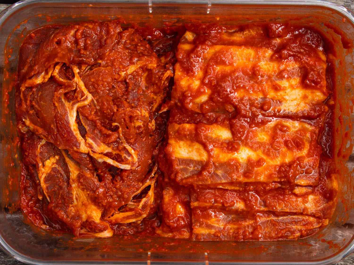 Thinly sliced pork shoulder and pieces of pork belly marinating for dwaeji bulgogi.
