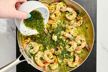 Overhead view of pouring chutney into pan