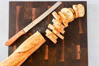 Tojiro F-737 Bread Slicer next to sliced bread