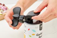 The Bartelli Soft Edge 3-in-1 Ambidextrous Safety Can Opener being used to open a can