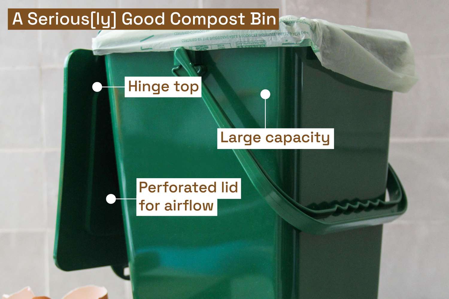 A green compost pail with a biodegradable liner