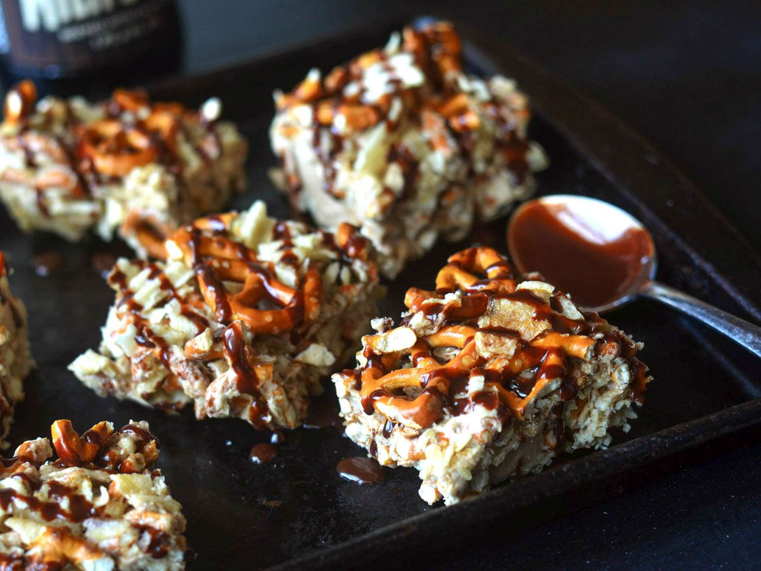 Closeup of the bars being drizzled with chocolate.