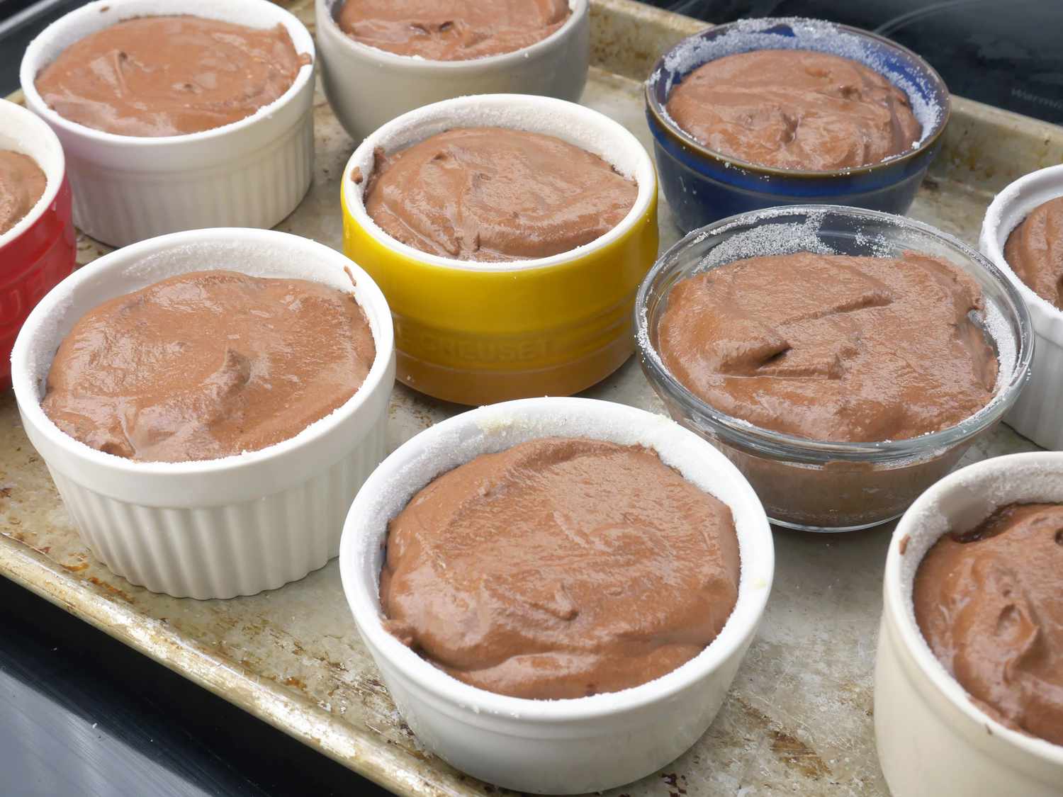 a variety of ramekins filled with mousse filling