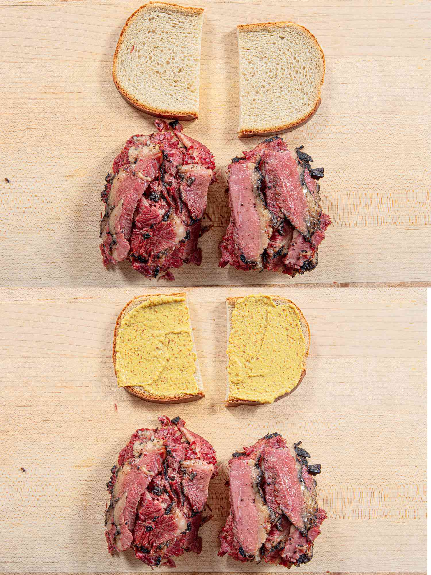 The assembly of a pastrami on rye sandwich, showing the open sandwich with sliced meat piled on it and mustard smeared on the top slices of bread.