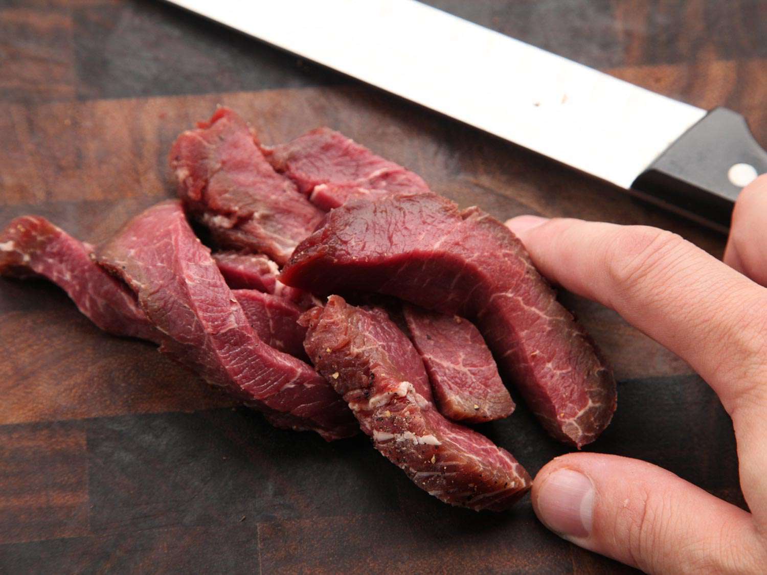 Slices of beef on a cutting board.