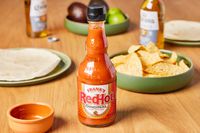 Frank's RedHot Original Cayenne Pepper Sauce ontable with chips