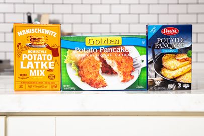 Three boxes of potato latke mix displayed on a countertop in a kitchen setting