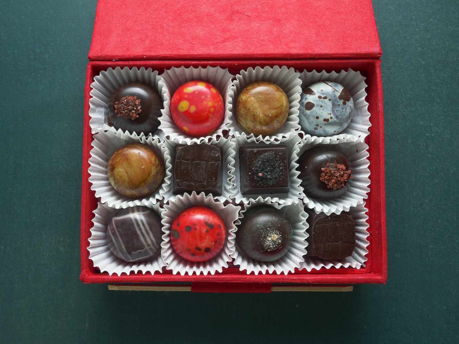 Knipschildt chocolate box opened to reveal 12 chocolates inside