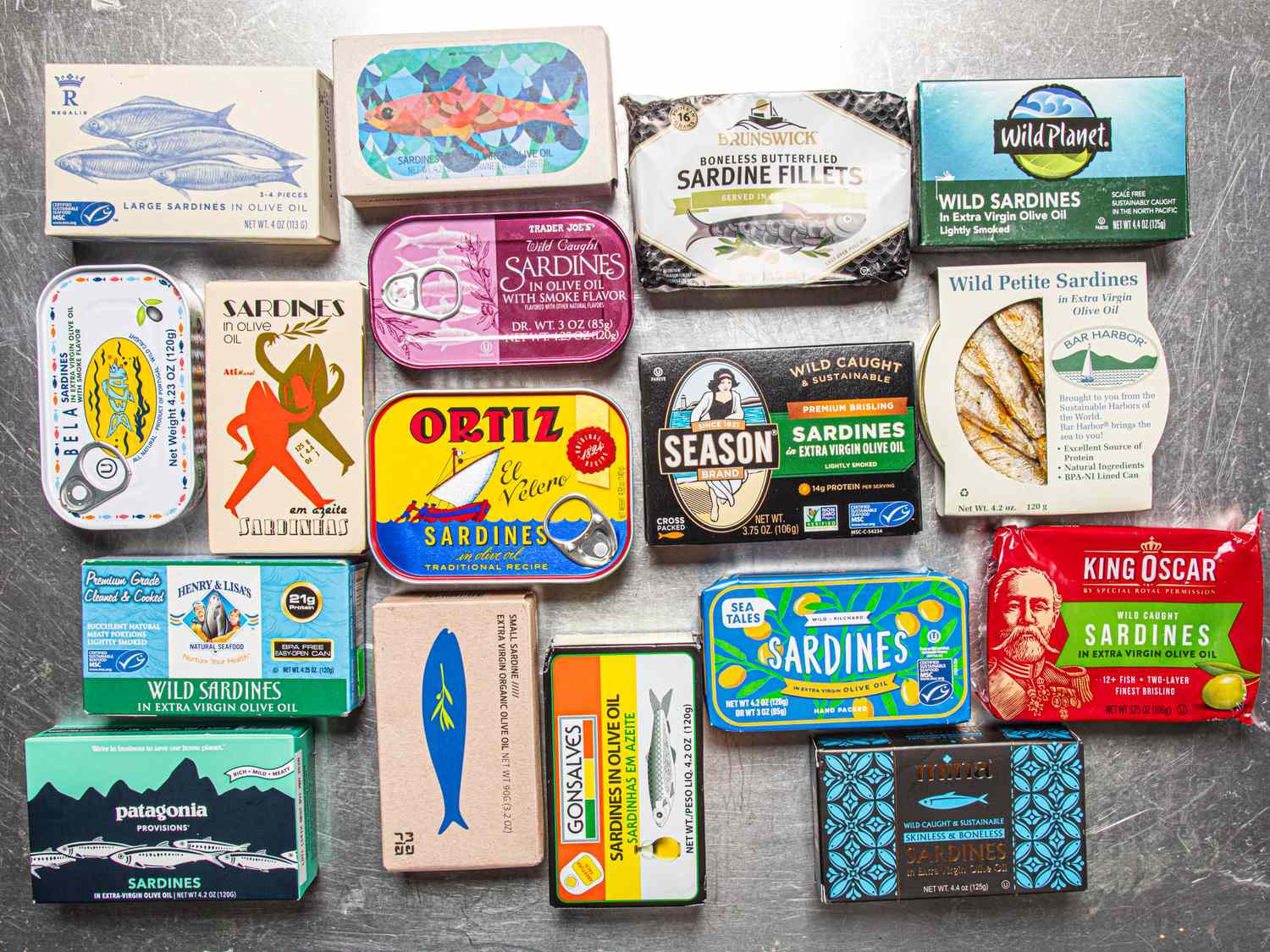 A collection of various tinned sardine packages arranged on a surface
