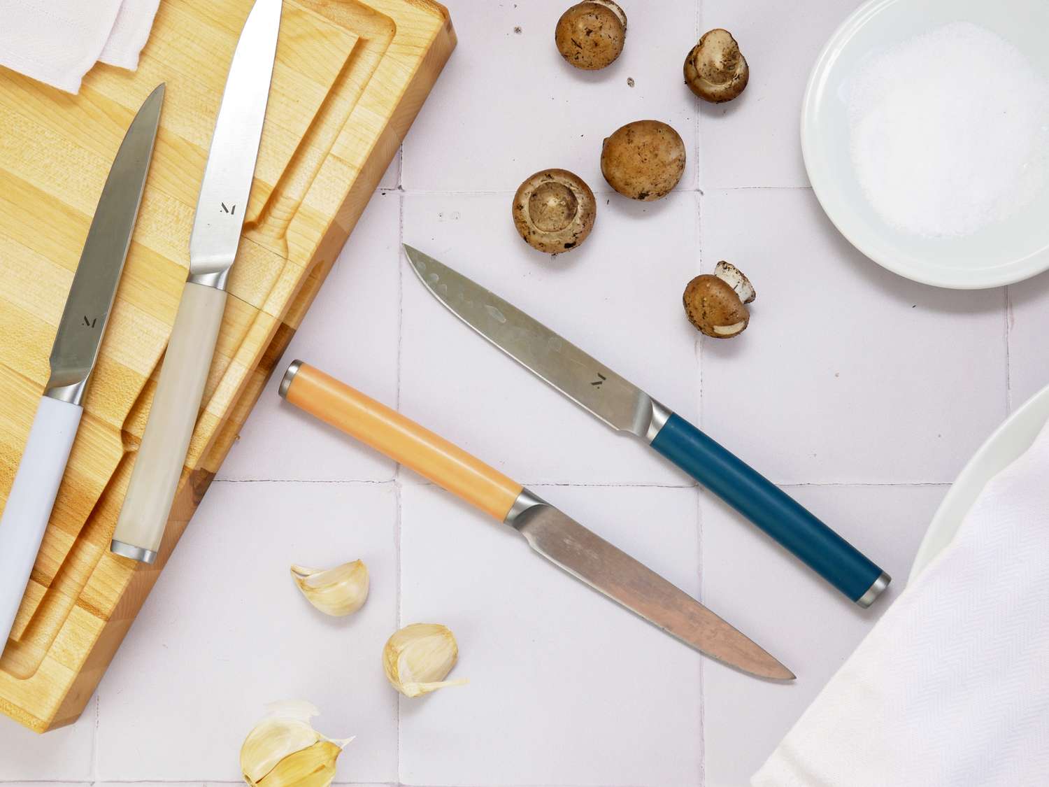 material knives on a white tile surface
