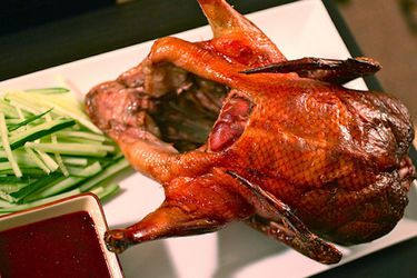 Whole roasted Peking duck with plum sauce and cucumbers. 