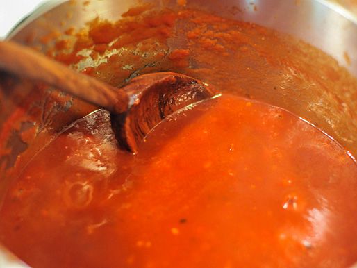 The sauce is simmered and stirred.