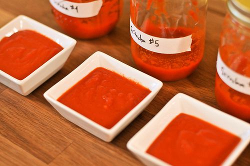 Small bowls of sriracha line up for a taste test. 