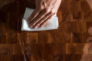 wiping mineral oil over a wood board