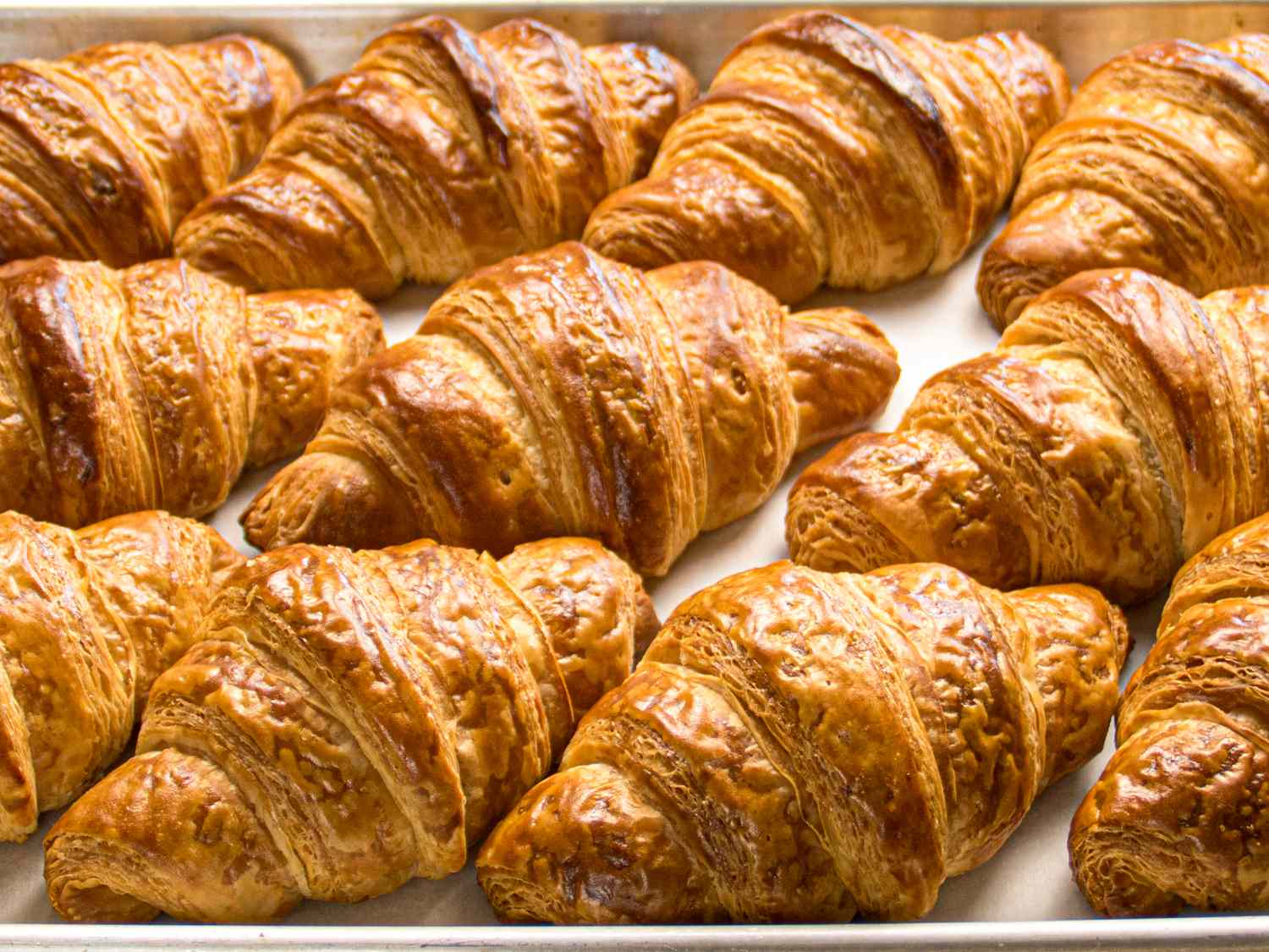 A tray of croissants arranged in rows