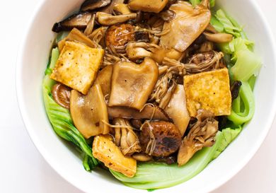 Overhead view of braised mushrooms, tofu, and Chinese mustard greens 