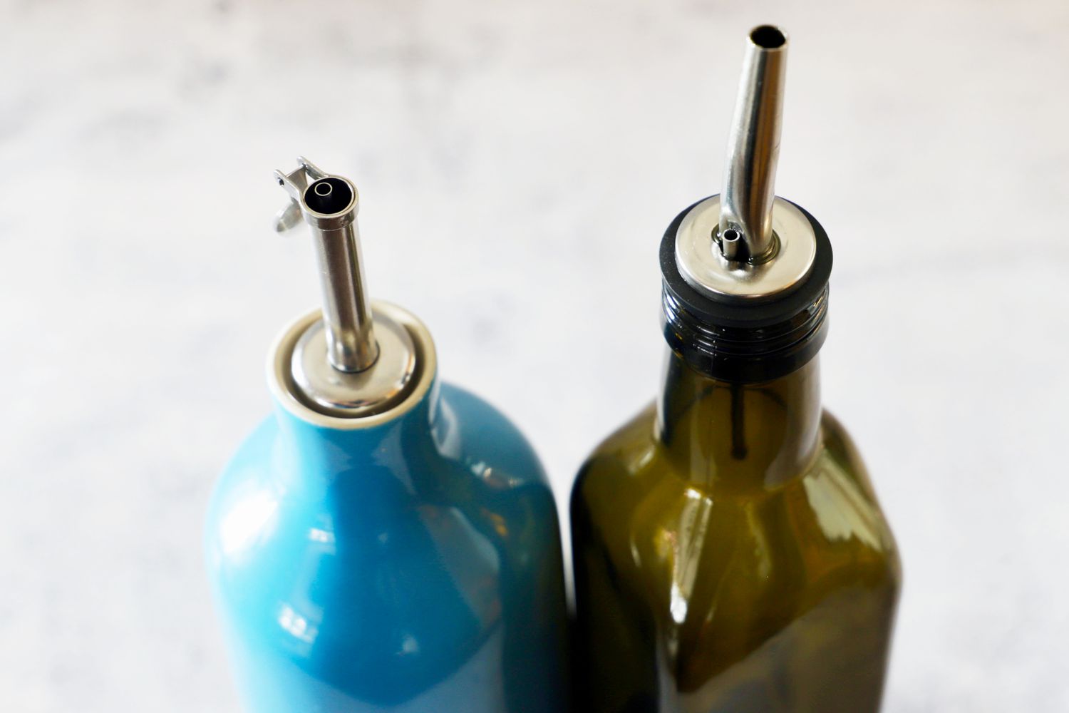 Two spouts of olive oil dispensers.