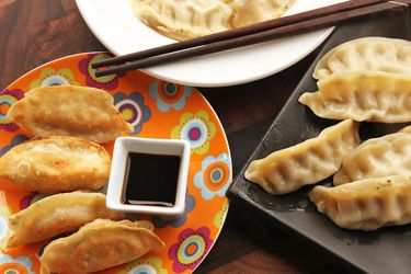 Serving plate of fried and steamed dumplings.