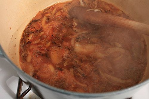 Deglazing the pan of onions with cider vinegar