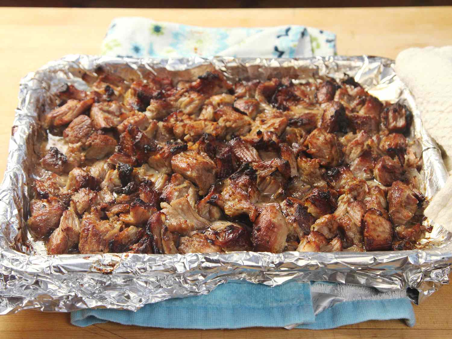 Crisp sous vide carnitas on a foil-lined baking sheet.