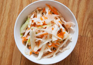 Overhead view of quick curtido in a white bowl.