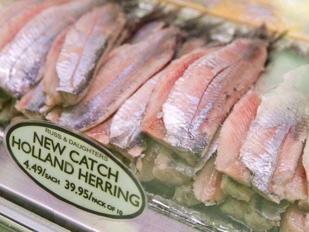 Closeup of pickled herring in the deli case at Russ & Daughters.