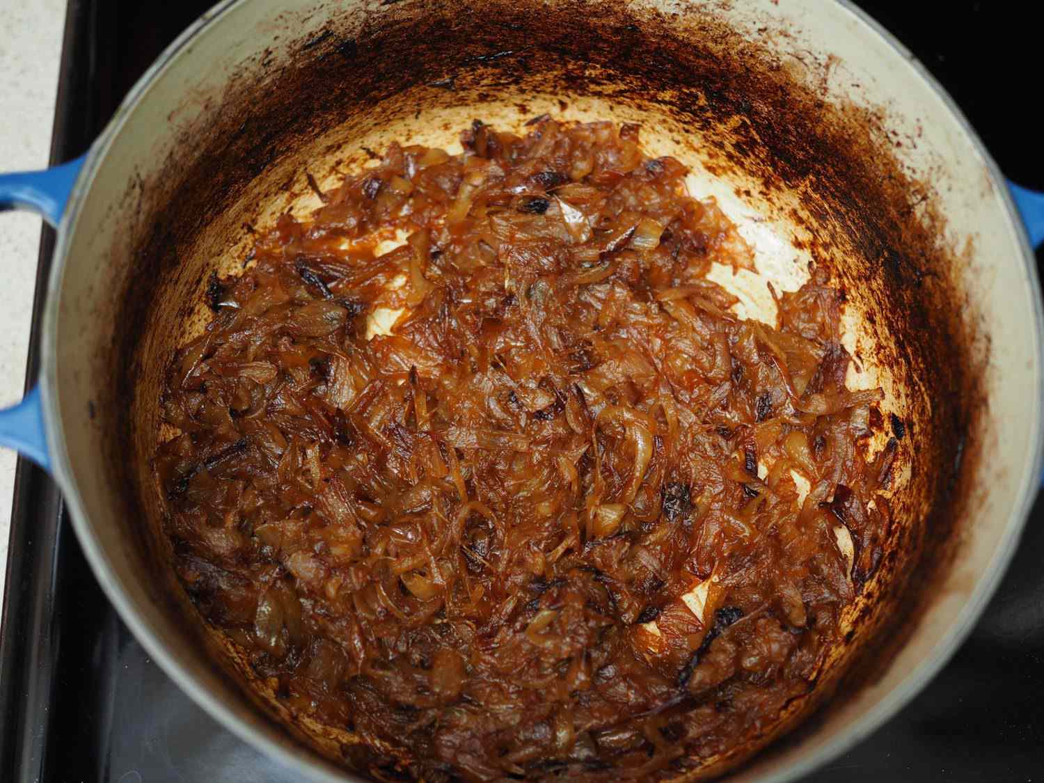 Onions caramelized in a Dutch oven.