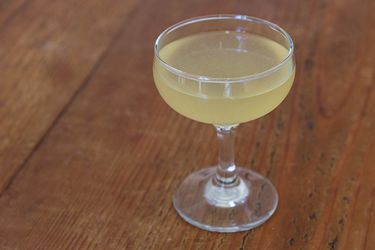 A bee's knees cocktail in a coupe. 