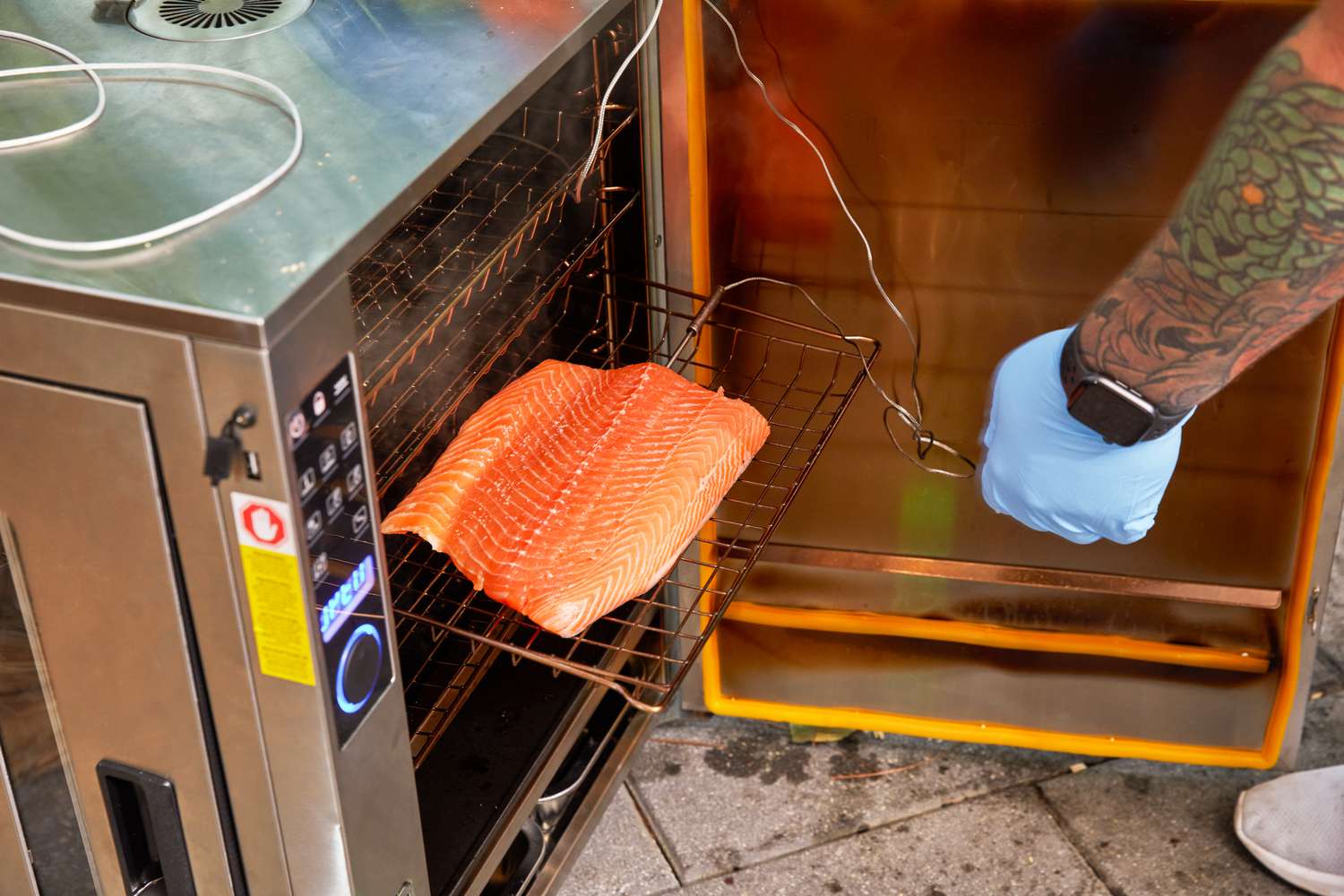 Salmon is cooked in the Bradley Professional P10 4-Rack Outdoor Electric Smoker (BS1019)