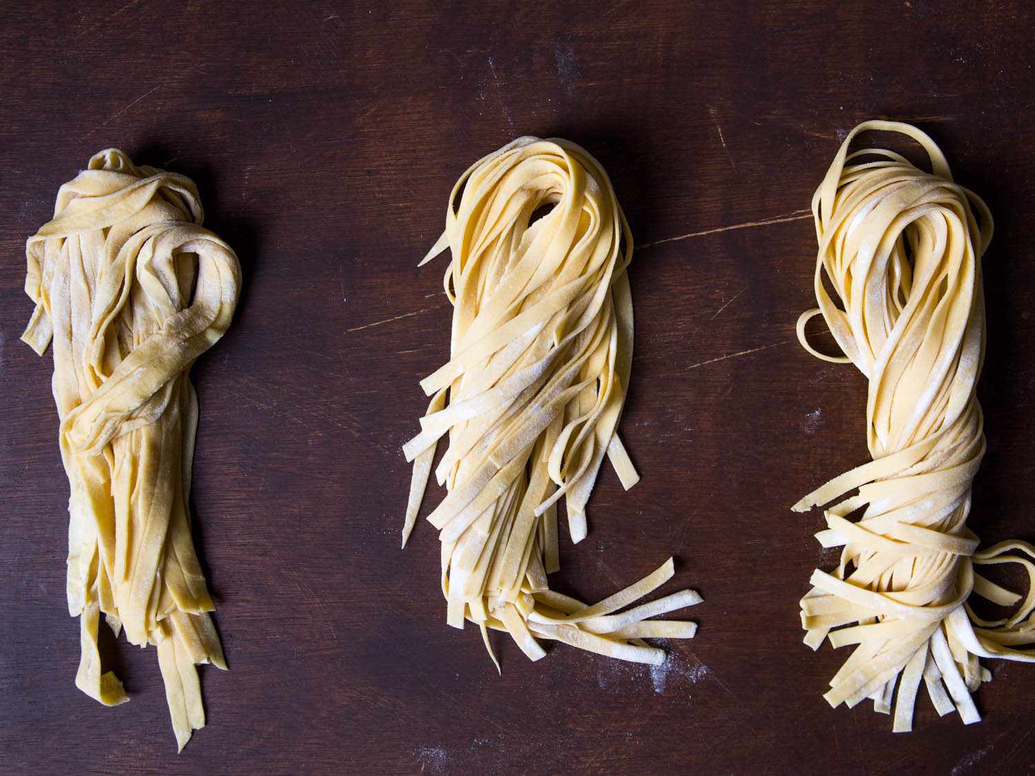 Three batches of strands of fresh pasta: the far left is wet and stuck together, the middle is just right (delicate and satiny), and the far right is too dry and stiff. 