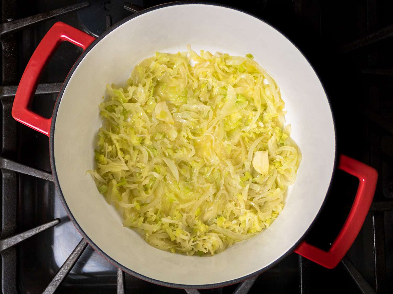 Leeks cooking in a Dutch oven.