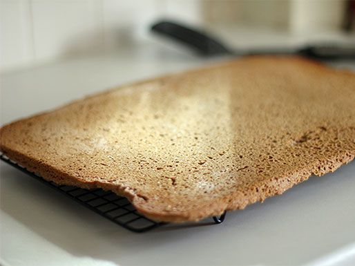 The sheet of grape nuts is unmolded and left to cool on a rack.