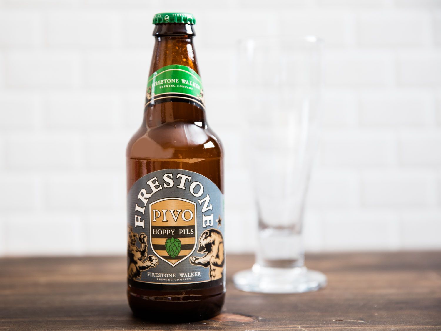 A bottle of Firestone beer, with a glass behind.