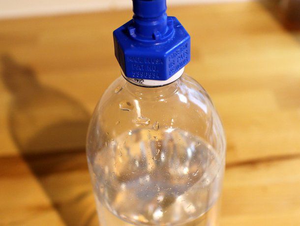 A bottle partially filled with water, showing ample headspace has been left.