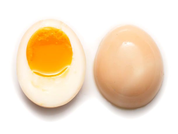 An overhead of a halved Ajitsuke tamago egg, one half has its cut side facing up.